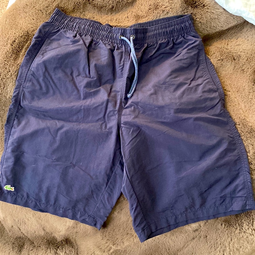 A Lacoste men’s quick-dry swim shorts with built in mesh lining.